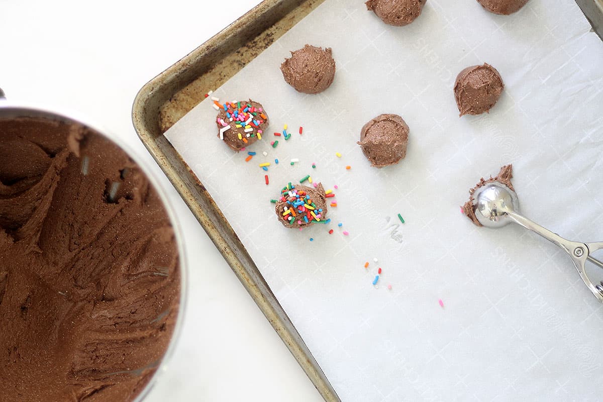 3-ingredient chocolate cake mix cookies with rainbow sprinkles on baking tray