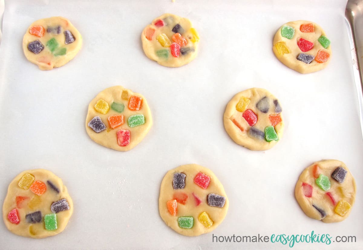 Gumdrop cookies on a parchment paper-lined cookie sheet. 