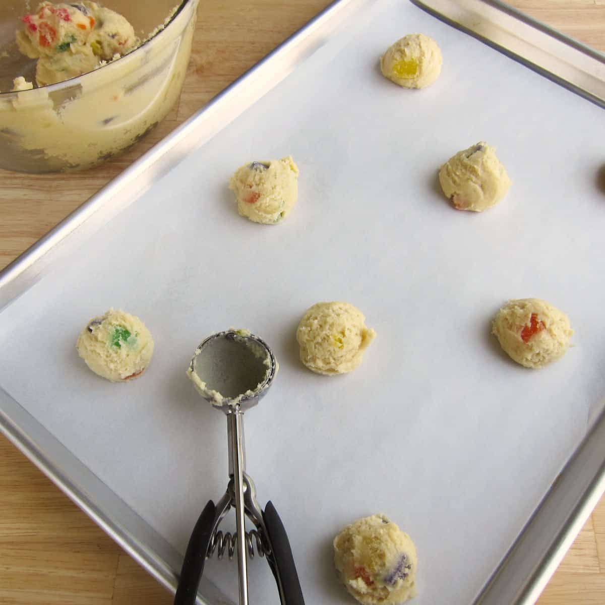 Scoop gumdrop cookie dough onto a parchment paper-lined cookie sheet.