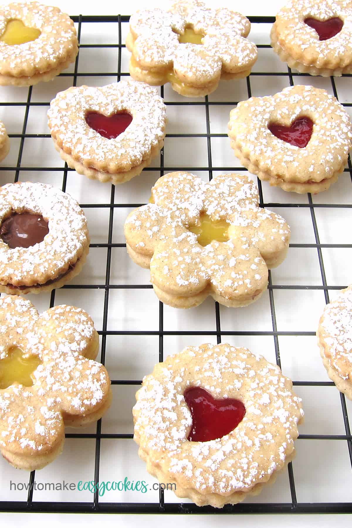 Linzer cookies filled with lemon curd, raspberry preserves, and Nutella.