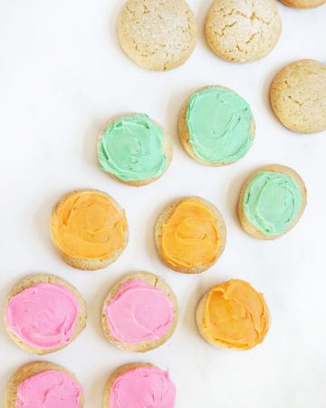sour cream cookies with pink, orange, and green buttercream frosting