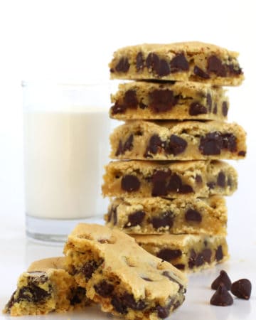 tall stack of soft and chewy chocolate chip cake mix cookies served with a glass of cold milk