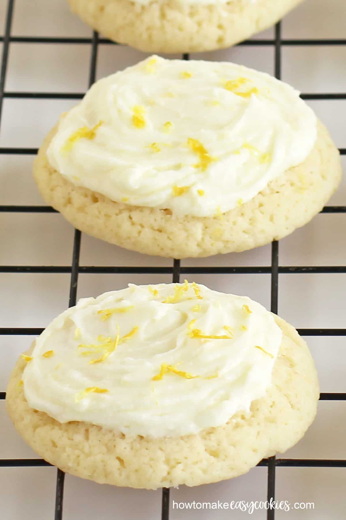 lemon cookies topped with lemon icing and lemon zest