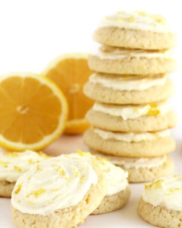 lemon drop cookies topped with lemon icing and lemon zest