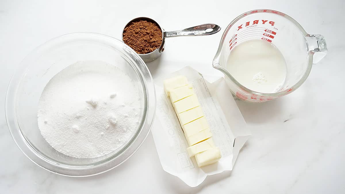 Ingredients for no bake cookies: cocoa powder, sugar, butter, and milk 