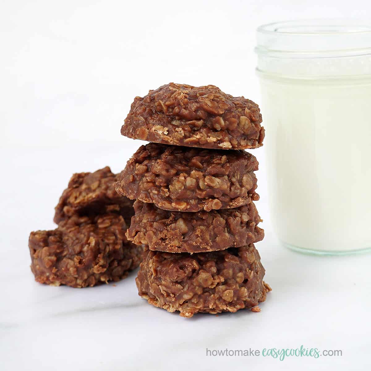 stack of no bake cookies with glass of milk 