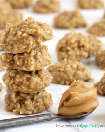 no bake peanut butter oatmeal cookies set in front of a spoonful of creamy peanut butter