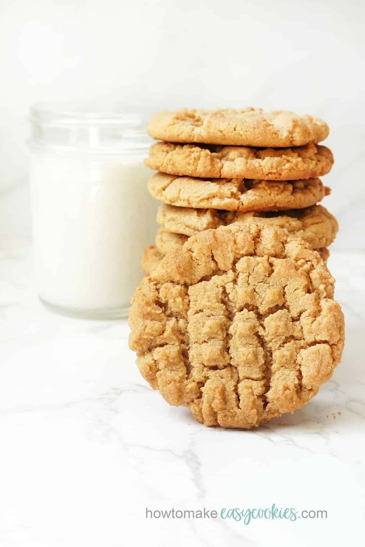 stack of flourless peanut butter cookies with glass of milk 