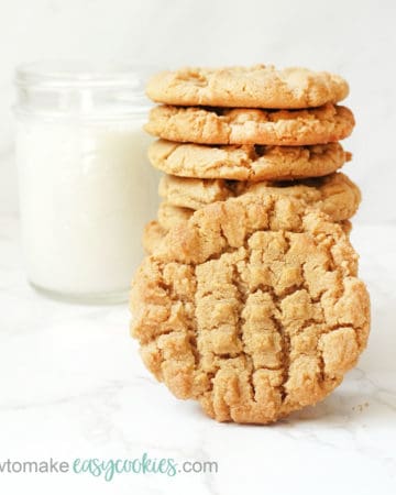 stacked peanut butter cookies with glass of milk