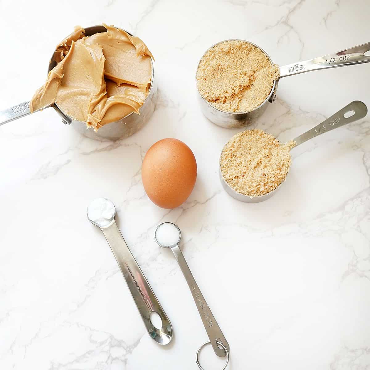 ingredients for flourless peanut butter cookies, peanut butter, egg, light brown sugar