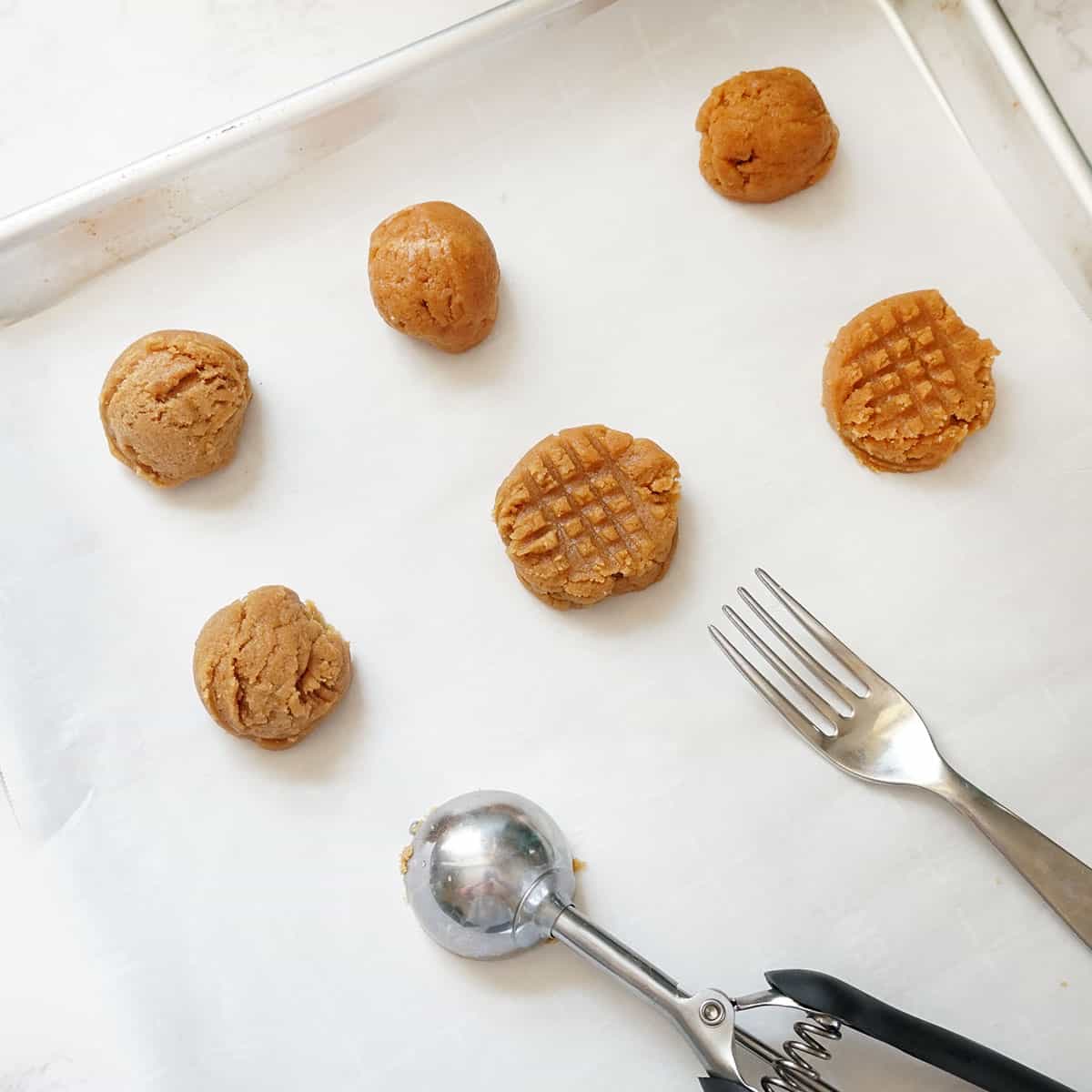 making flourless peanut butter cookies on baking tray