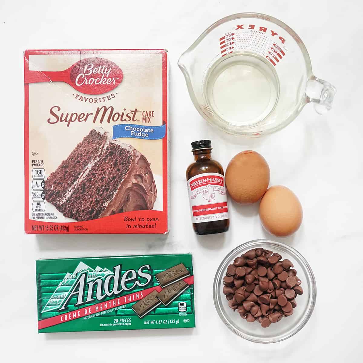 ingredients for mint chocolate cake mix cookies, cake mix, eggs, vegetable oil, peppermint extract, andes thins, chocolate chips