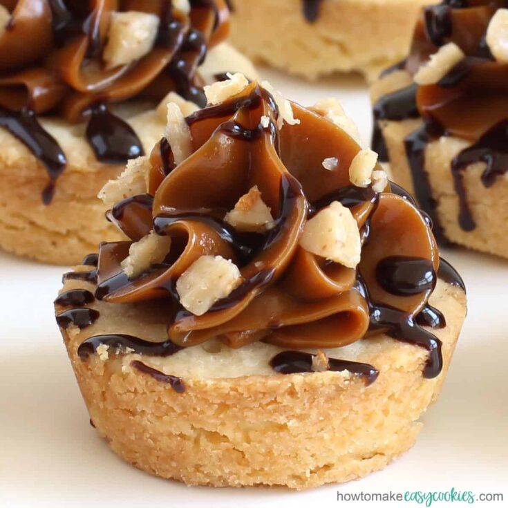 shortbread cookie cup topped with caramel, chocolate, and toffee bits