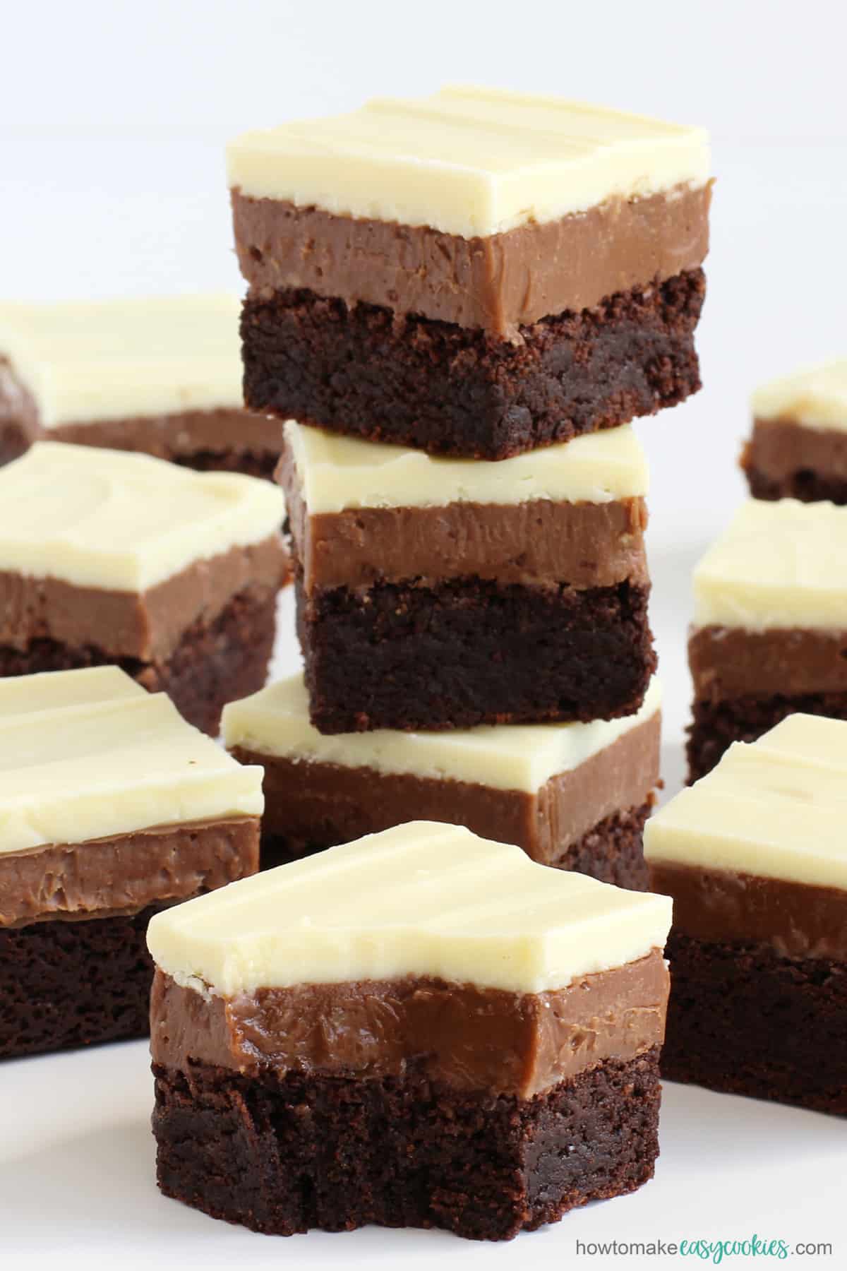 white, milk, and dark chocolate cookie bars stacked up showing the three layers