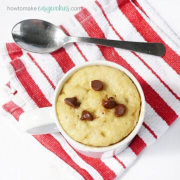 overhead view of microwave chocolate chip mug cookie with spoon