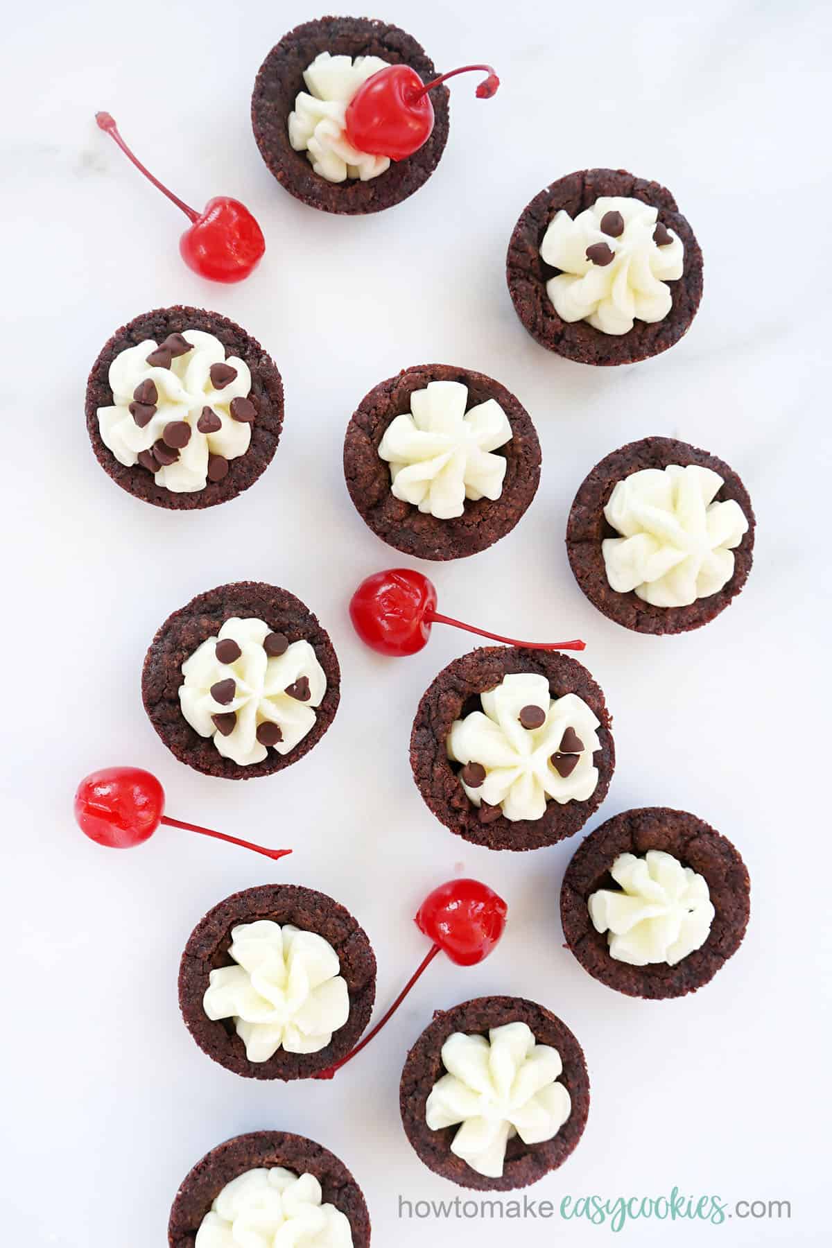 maraschino cherries and chocolate cookie cups with frosting