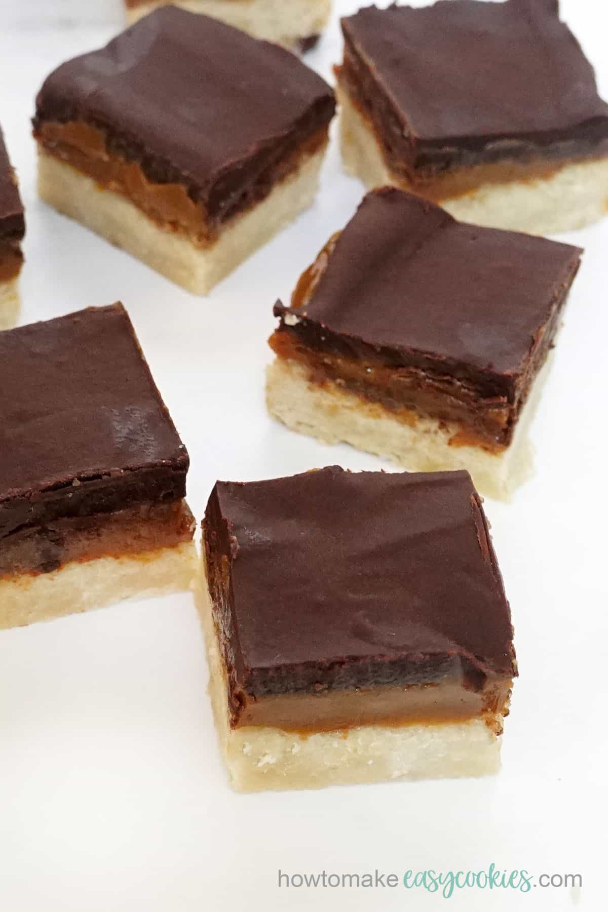 batch of caramel slice cookie bars with chocolate ganache