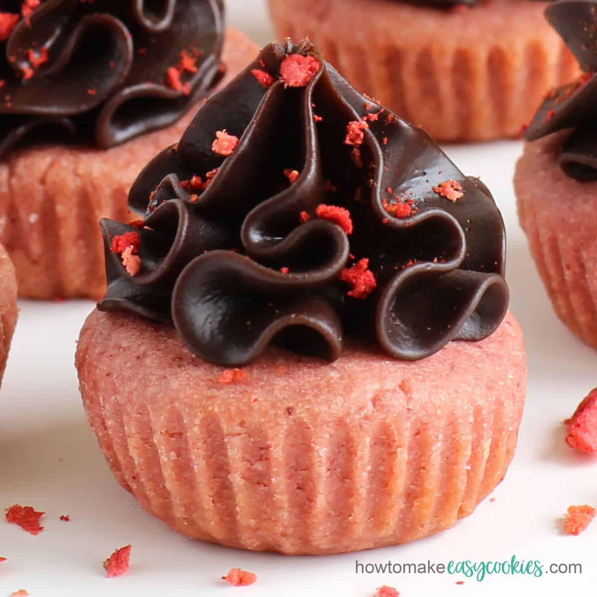 chocolate ganache frosting on strawberry cookie cups