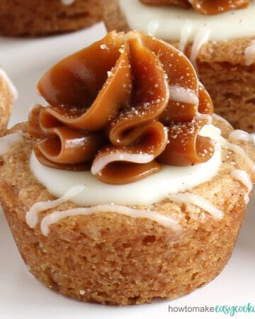 a Snickerdoodle cookie cup topped with a swirl of dulce de leche caramel and white chocolate ganache