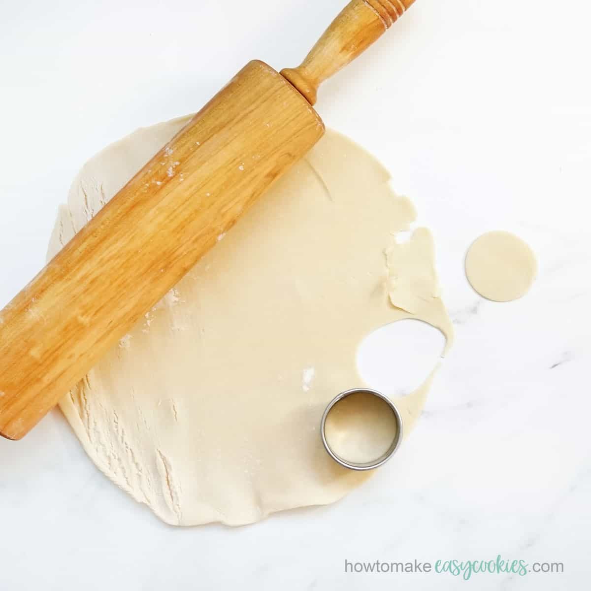 rolling out store-bought pie crust for cookies
