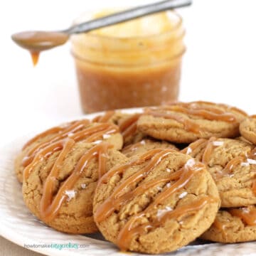salted caramel cookies drizzled with caramel sauce and sprinkled with salt flakes