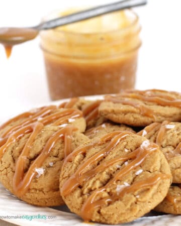 salted caramel cookies drizzled with caramel sauce and sprinkled with salt flakes