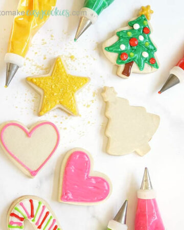 cut-out sugar cookies with powdered sugar and decorate with royal icing
