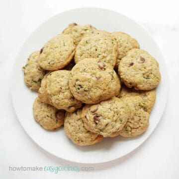 zucchini chocolate chip cookies piled on a white plate