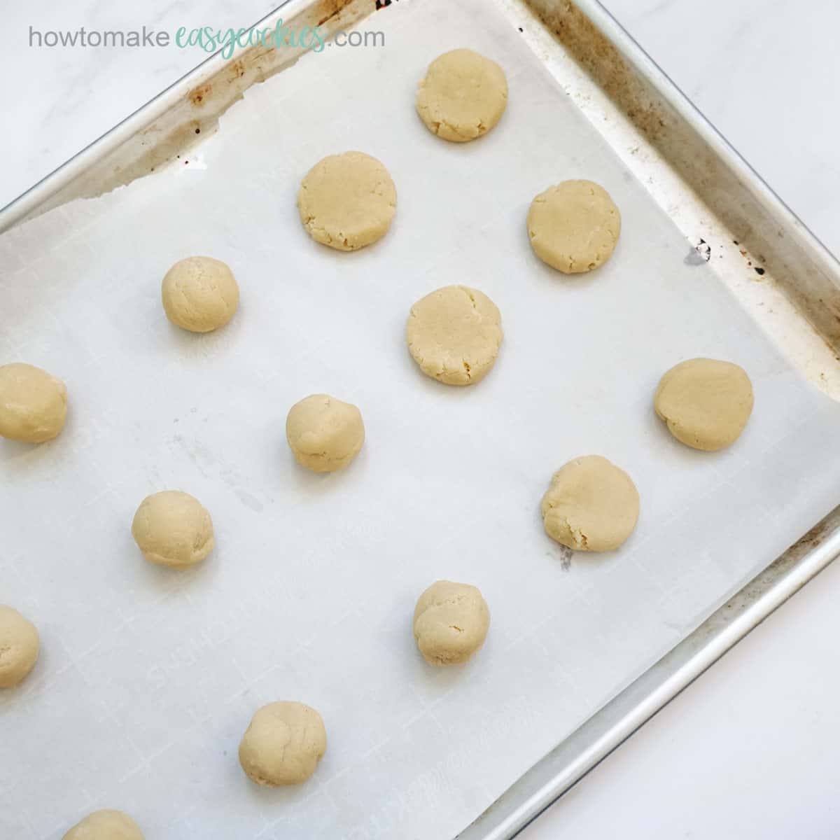 balls of cookie dough on baking tray