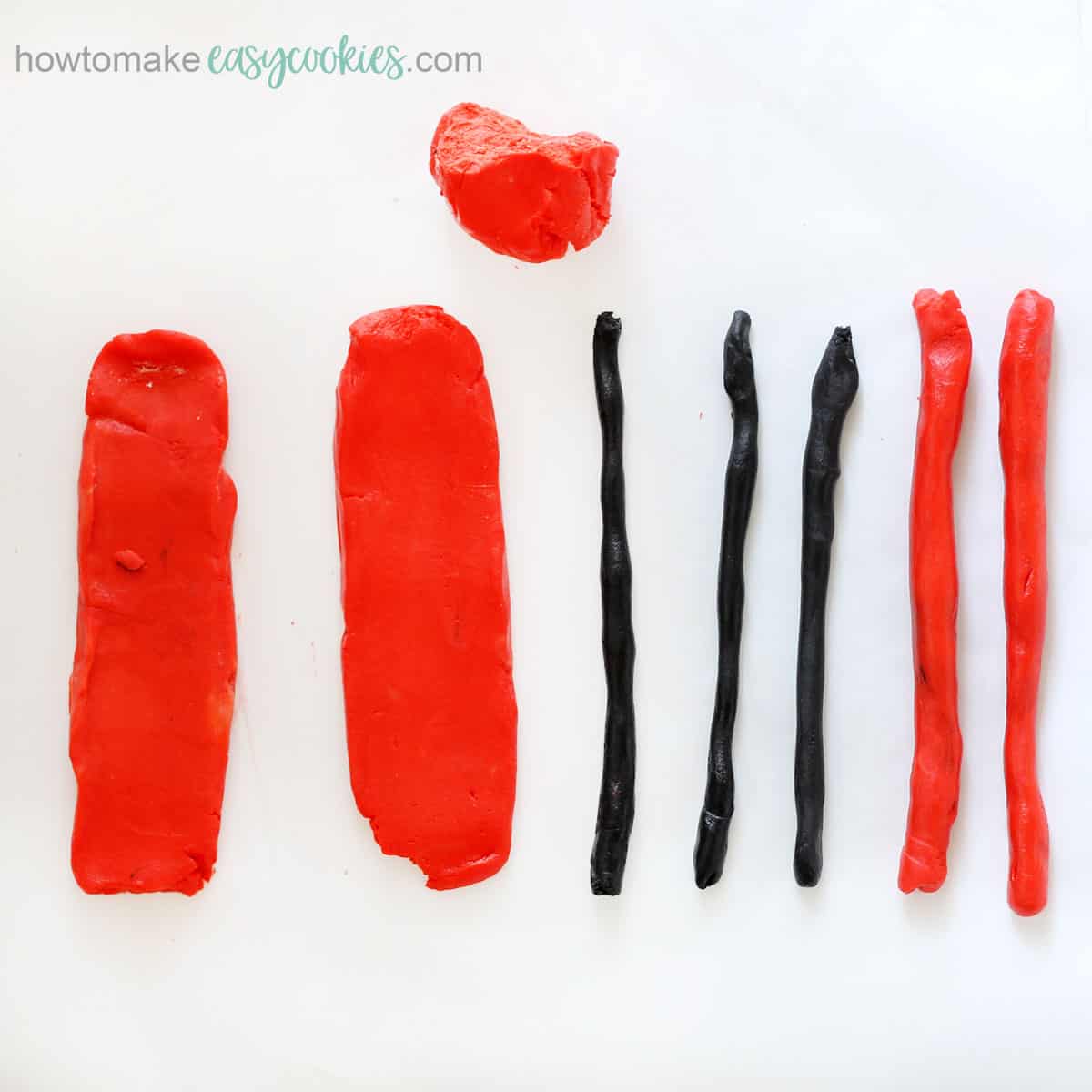 rolled out red and black dough for bug cookies