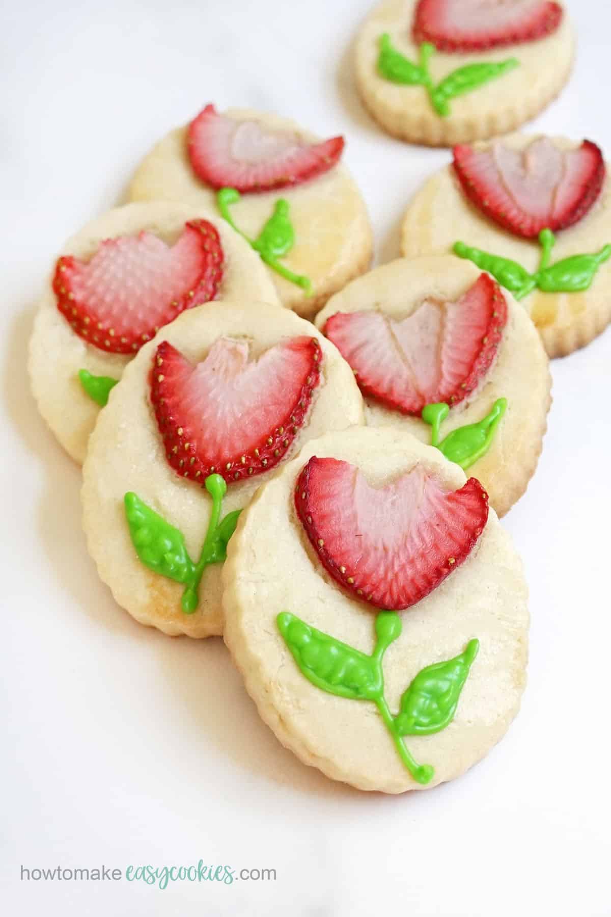 strawberry tulip flower cookies with piped sugar cookie icing