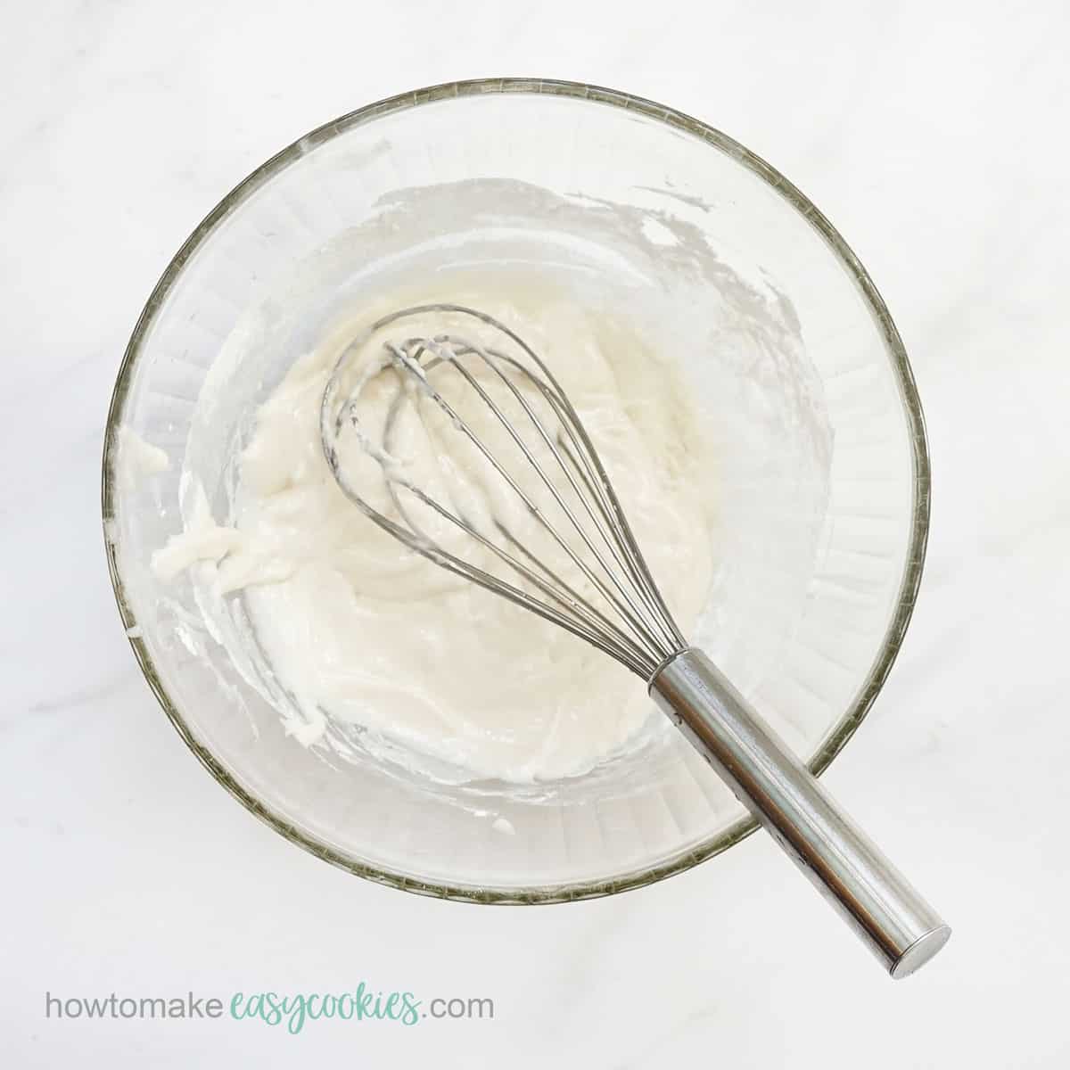 sugar cookie icing in bowl with whisk