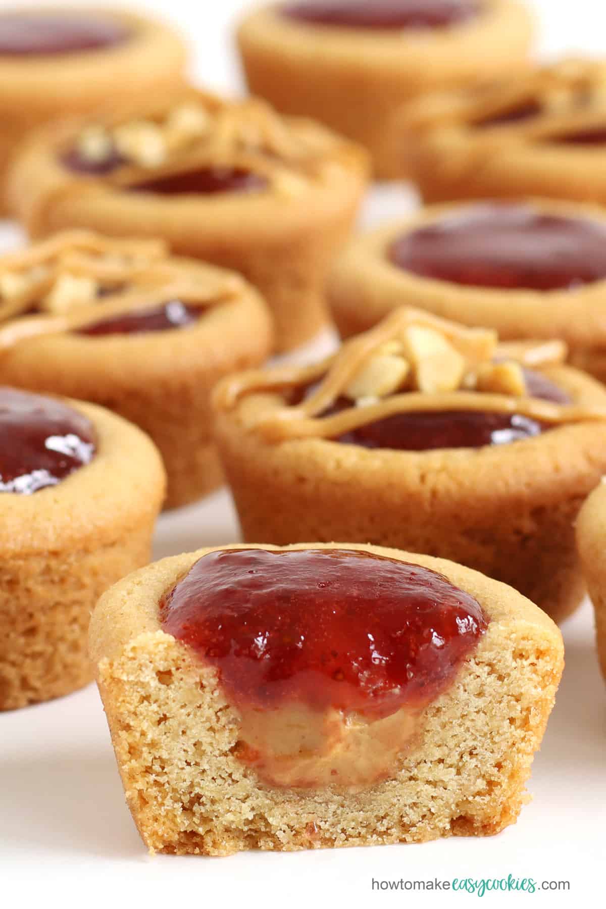 PB&J Cookie Cups filled with creamy peanut butter and strawberry jelly and sprinkled with chopped peanuts
