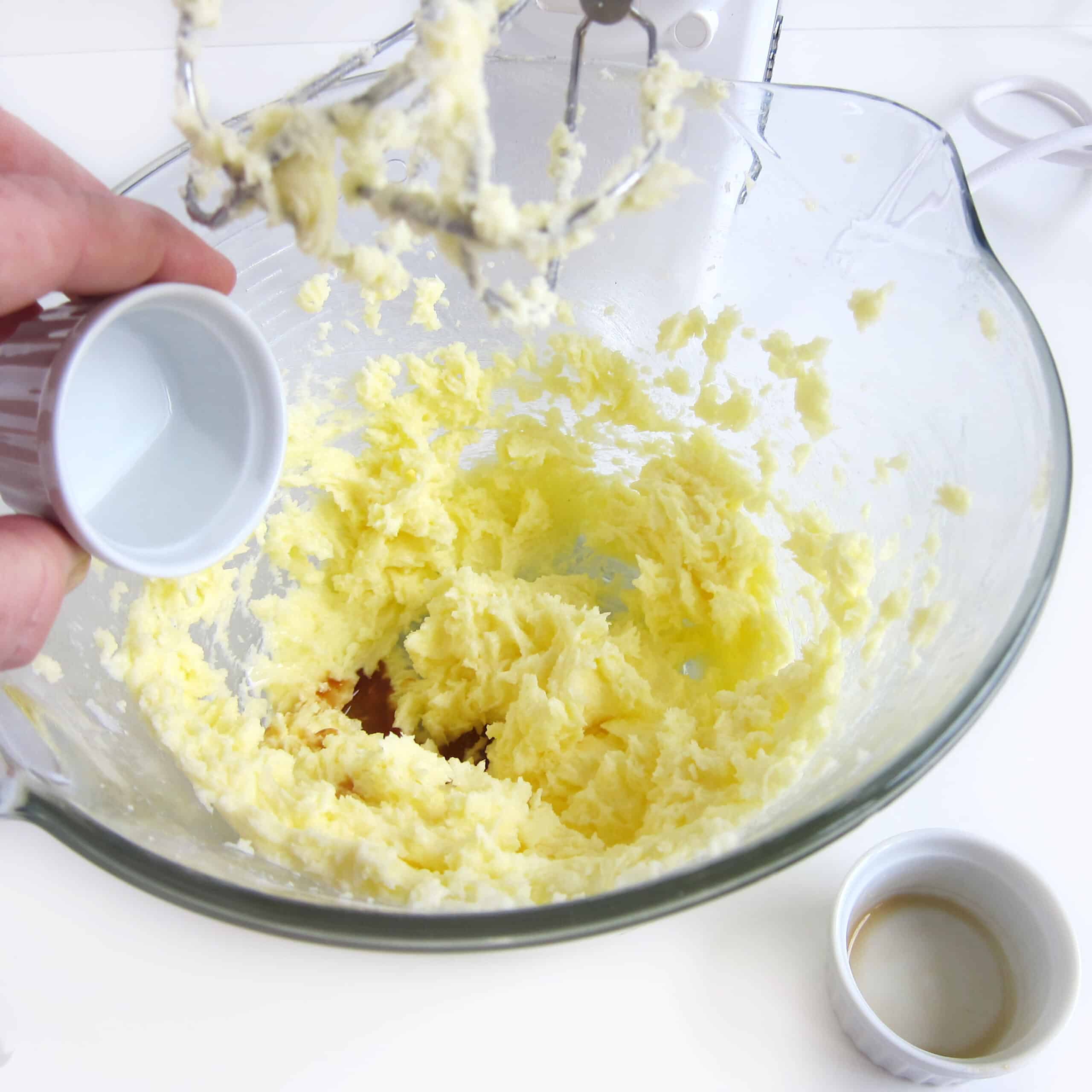 Add vanilla and almond extract to the butter, sugar, and egg mixture.