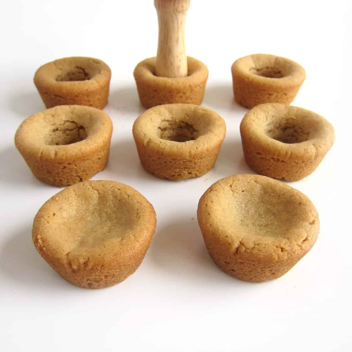 press a wooden spoon handle into the peanut butter cookie cups