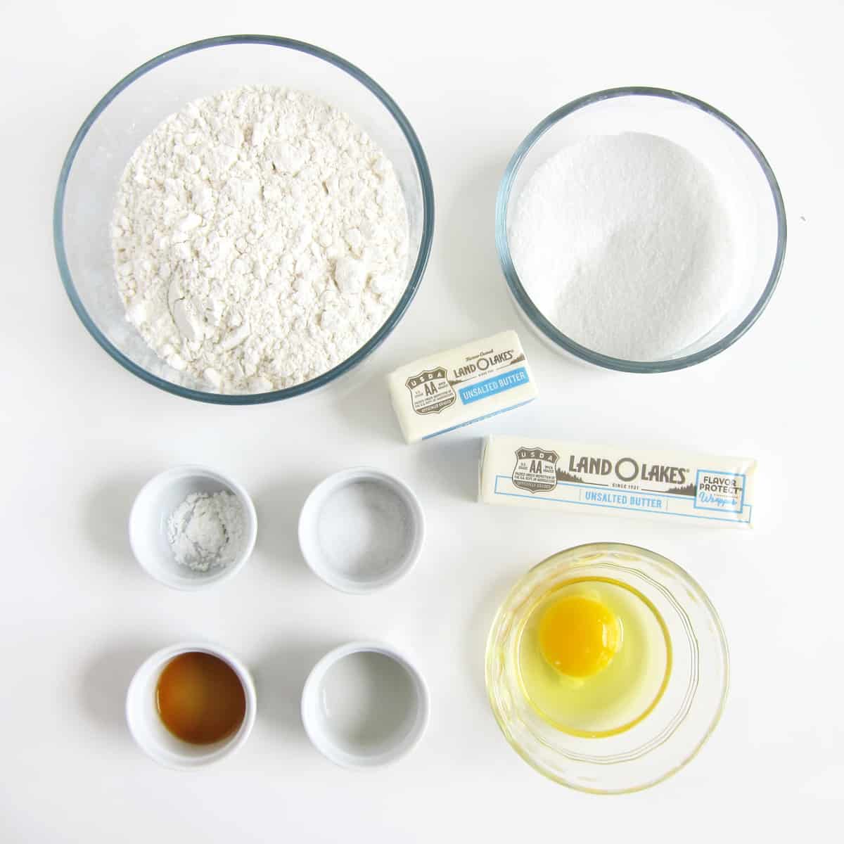Ingredients for sugar cookie cups including flour, baking powder, salt, sugar, butter, egg, vanilla, and almond extract. 