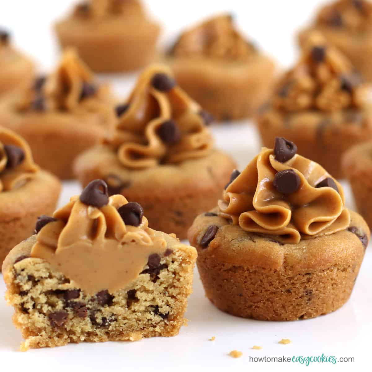 mini peanut butter chocolate chip cookie cups topped with creamy peanut butter and mini chocolate chips