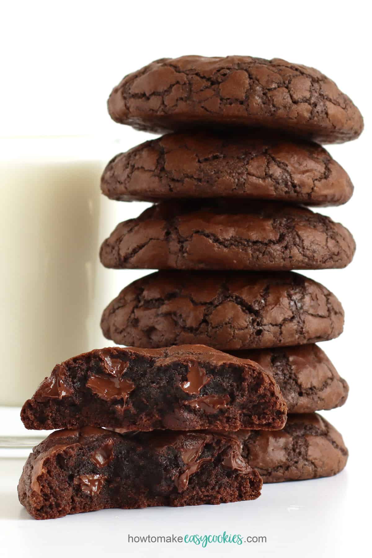 Thick and chewy double chocolate brownie mix cookies stacked up next to a glass of milk.