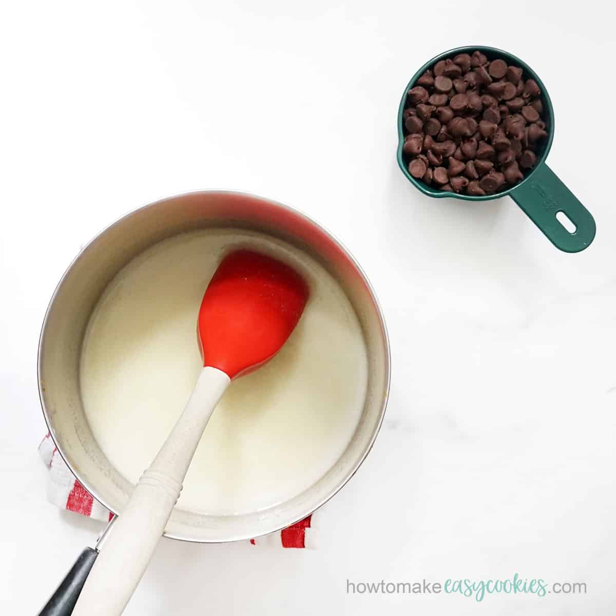 mixing butter and sugar in saucepan and adding chocolate chips
